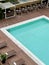 View from above on swimming pool with lounging chairs