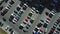 A view from above to the process of car parking. Heavy traffic in the parking lot. Searching for spaces in the busy car