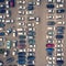 A view from above to the ranks of head-in parked cars.End-to-end parking. Cruising for parking space. Trouble-free navigation in