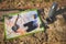 View from above of tourist's clothes, map, compass, binoculars and thermos flask lying down on the rock. Still life