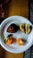 View from above of tropical fruits of salak and oranges, one salak and one orange are split in half