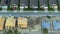 View from above of unfinished frames of private homes with wooden roofs under construction on rural street. Development