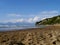 View across dark sandy beach to the sea