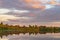 View across the Ellesmere Mere to a clear reflection of distant trees