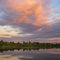 View across the Ellesmere Mere to a clear reflection of distant trees