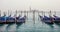 A view across the lagoon in Venice with gondolas on a misty day
