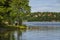 View across Lilla Vartan strait onto the shoreline of Stockholm suburbs, Lidingo island with traditional houses, Sweden