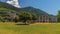 A view across a park towards the remains of the Roman amphitheater in front of the city of Gubbio, Italy