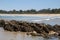 View across rocks and bay to sandy beach