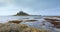 View across rocky foreshore at low tide, towards St Michaels Mount, Marazion, Cornwall