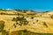 A view across the Sicilian fields in the Madonie Mountains, Sicily towards the hilltop village of Petralia Soprana