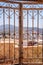 View across Thira on the Greek island of Santorini through wrought iron gates