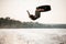 view on active male wakeboarder doing somersault in the air above water