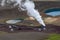 View at active steam stack and parts of Krafla geothermal power plant next by the volcano crater with Krafla Viti lake in Northern