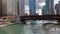View of activity on the Chicago River including kayaks, water taxi, tour boat, docked recreational boats