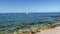 View at the Adriatic Sea in Portonovo with waters, rocks, bather and boats