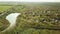 View from the air. fields and a country village by a small pond.