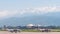 View from the airfield of Almaty on the Zaili Alatau. Various airplanes are parked on the airfield