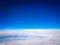 view from airplane in height of cruise of blue sky with the wake of another airplane and in the inferior part of the photograph a