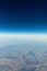 View from the airplane to the sky above the Alps mountains. Blue