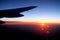 View from airplane window with the african sunrise with warm and cold colours in the horizon