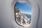 View from airplane window on Alps mountains.