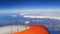 View from the airplane window of a bright orange turbine flying over the white snowy peaks of the mountains of Turkey 22.