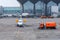 View of the airport apron, a standing passenger plane, a cleaning truck. In the background terminal