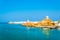 View of the Al Ayjah town, two watchtowers and a dhow under repair from the Khor Al Batah bridge in Sur, Oman...IMAGE