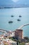 View of Alanya harbour, ships and Kizil Kule Red Tower, ancient stone wall of Alanya Castle. Alanya, Turkey