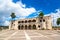 View of Alcazar de Colon Diego Columbus Residence from Spanish Square with blue sky. Famous colonial landmark in Dominican