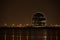 View of Aldar headquarters building and night skyline of Abu Dhabi