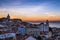 View of the Alfama neighborhood from the Portas do Sol viewpoint at sunrise in Lisbon, Portugal