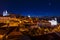 View of the Alfama neighbourhood from the Portas do Sol viewpoint at night in Lisbon, Portugal