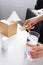 View of allergic woman holding blister pack with pills and glass of water and tissue box