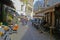 View on alley with exterior cafes and restaurants people sitting outside in historical center on sunny winter day