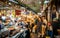 View of an alley of the Kwangjang market at night with people eating street food at stalls