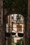 View of an alley in Spello town Umbria, Italy with some old copper pots hanging on the rooftop of an arch