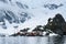 View of the Almirante Brown Station from the water, line of tourists hiking in the background, Paradise Harbor, Antarctica