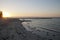 View along the beach at sunset, with ocean bathes in background