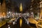 View along the Groenbuigwal canal towards the Zuiderkerk church at night.