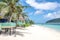 View along Lalomanu Beach, Upolu Island, Samoa, of colorful Samoan beach fale huts that are an alternative to hotel or resort