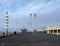 View along the pedestrian promenade in blackpool with traditional wooden shelters and lights with the town buildings in the