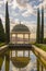 View along a pool towards historic viewpoint and symbol of the botanical garden in Malaga