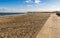 A view along the promenade off Skegness beach, UK towards the remains of the pier