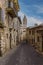 A view along a side street towards the Cathedral of Saint Rufino in Assisi, Umbria