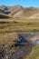 View along small creek to stone caravanserai of Tash Rabat