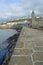 View along the stone pier toward the Clock Tower at Porthleven, Cornwall