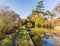 A view along the towpath of the Grand Union canal towards a perfect circle formed by a bridge and it`s reflection