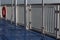 View alongside deck railing with red life preserver on a ferry ship